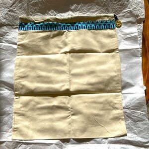 Drawstring dust bag by Tory Burch.